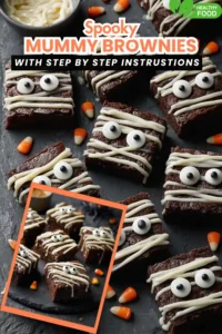 Halloween mummy brownies decorated with white icing bandages and candy eyes on a dark background