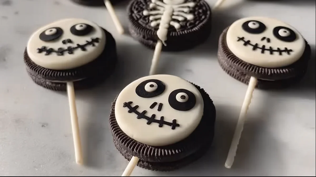 Oreo pops decorated with white chocolate skull faces on sticks