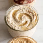 creamy overnight oats in a glass jar swirled with chia seeds and honey