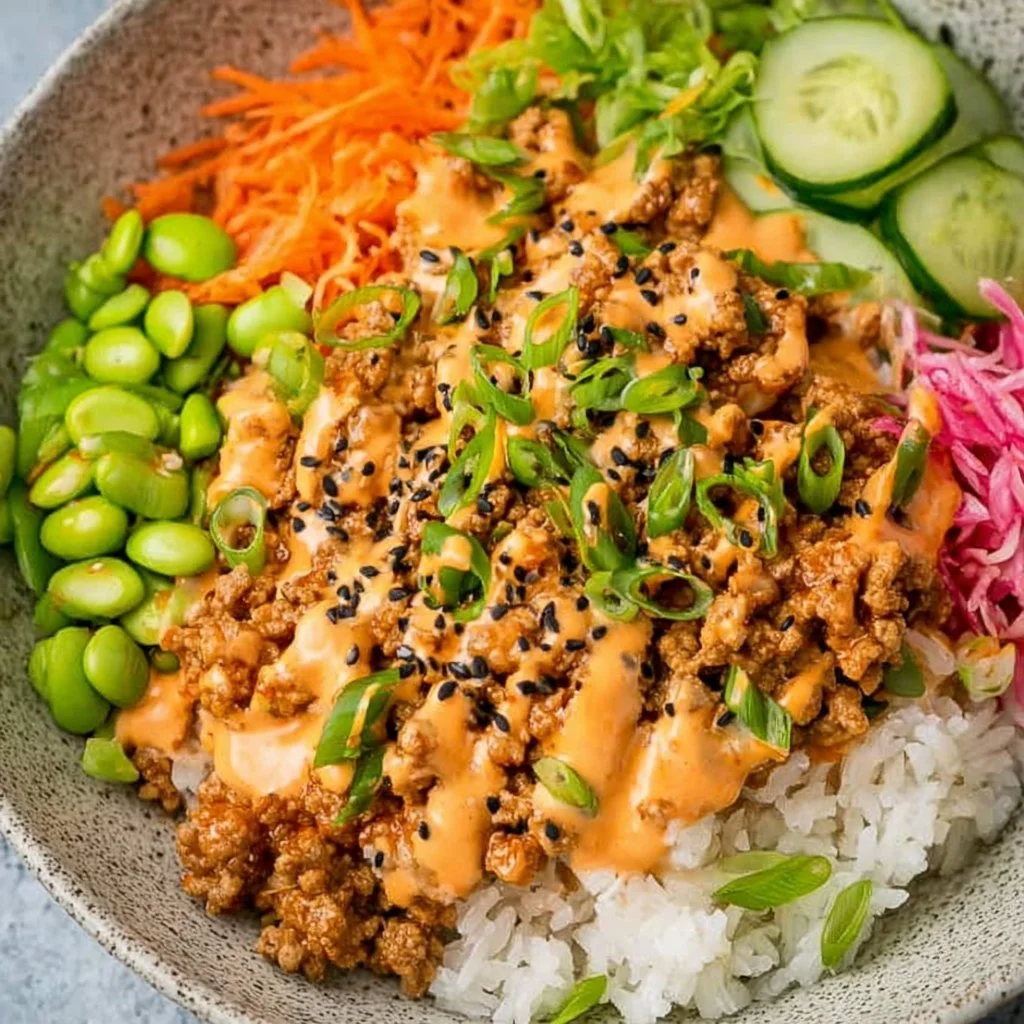 Healthy ground turkey rice bowls with spicy Bang Bang sauce on top