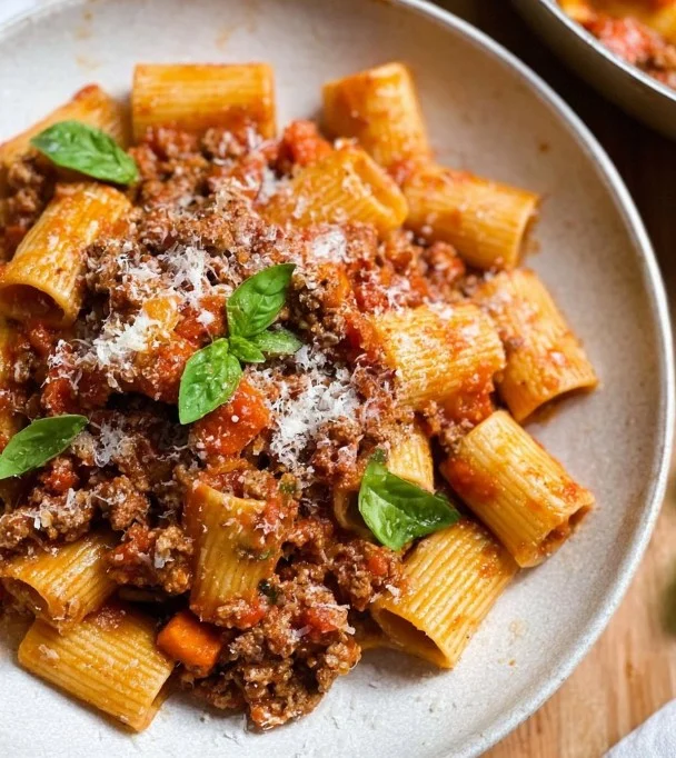 A bowl of classic Bolognese sauce served over pasta for family dinner.