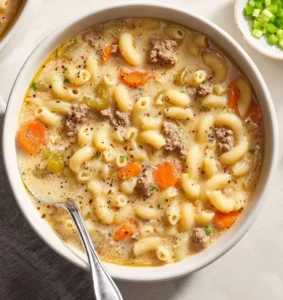 Bowl of creamy one-pot cheeseburger soup topped with cheese and herbs